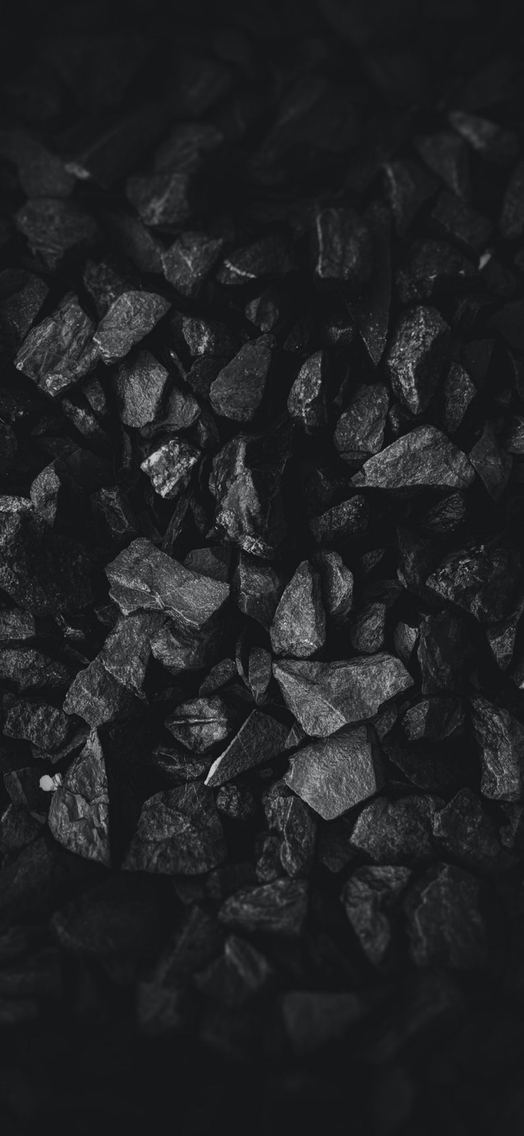 A black and white image of a pile of coal - Black